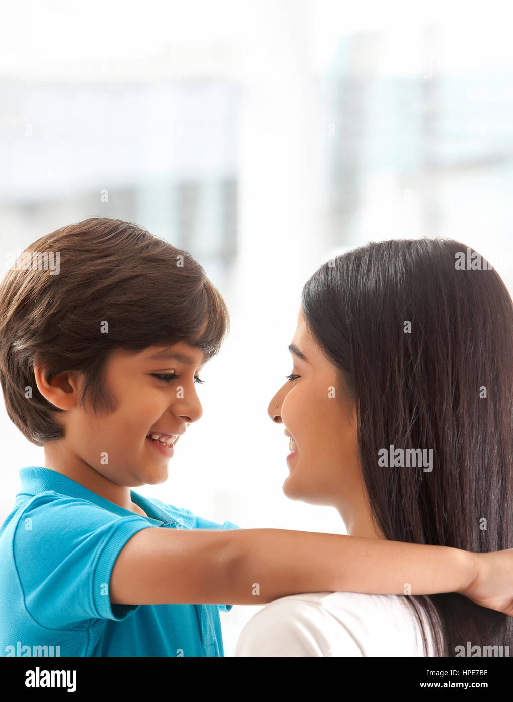 Close up of smiling son and mother face to face Stock Photo