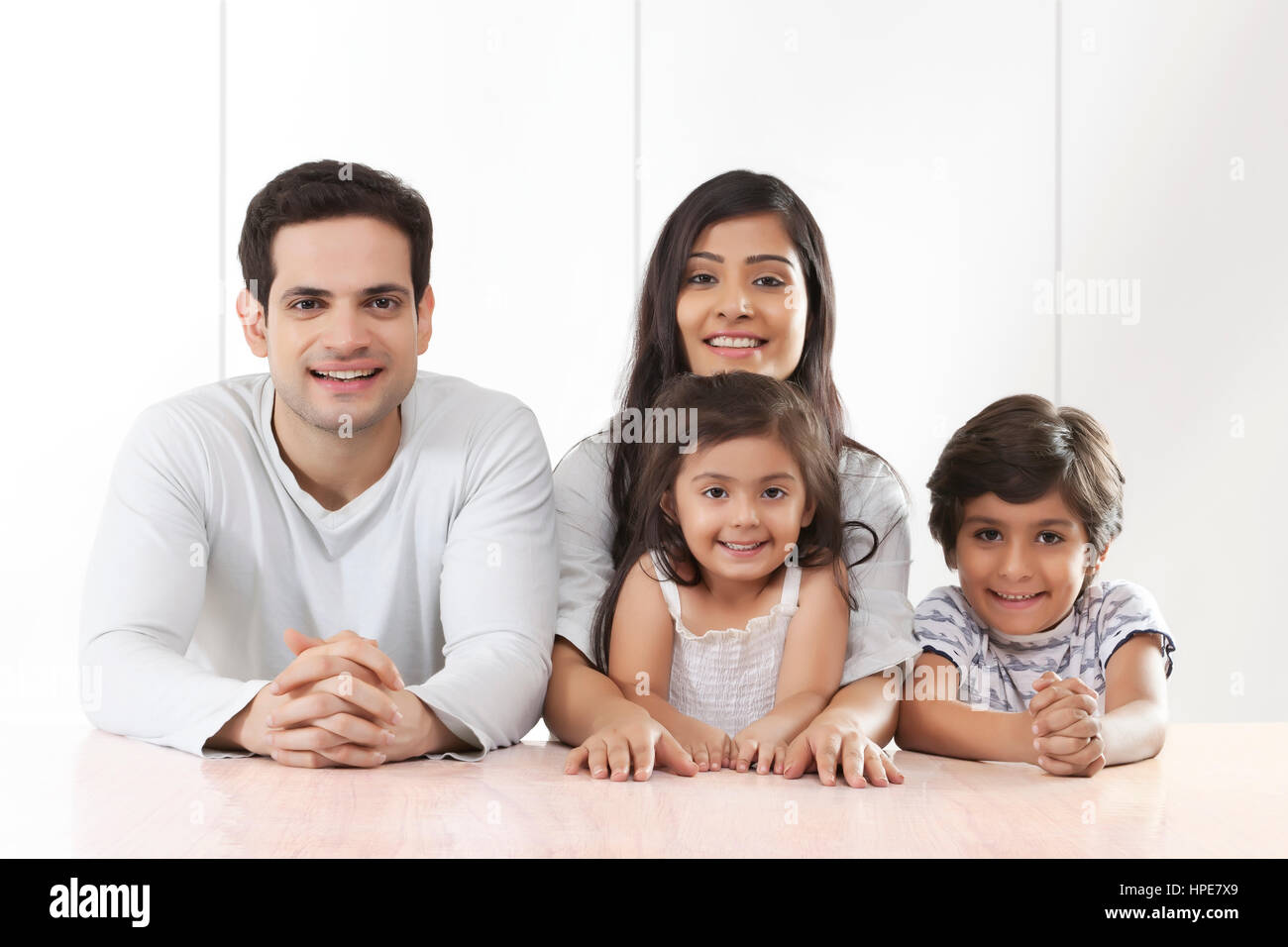 Portrait of parents with their son and daughter smiling Stock Photo