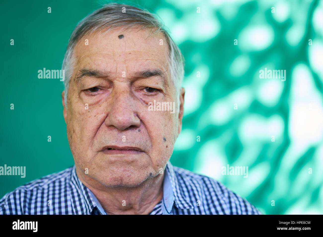 Real Cuban people and emotions, portrait of sad mature latino man from Havana, Cuba looking at camera with worried face and depressed expression Stock Photo