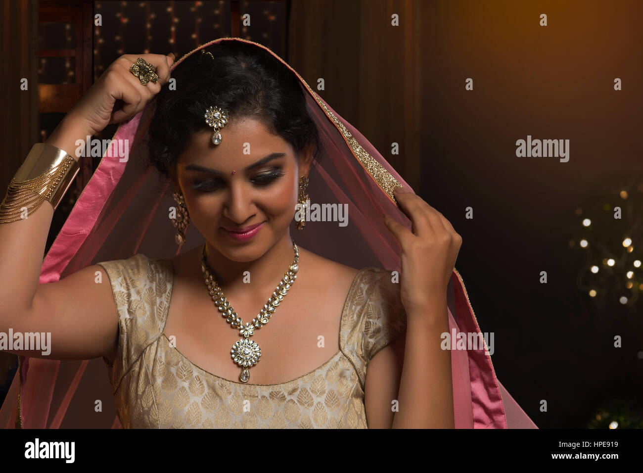 Smiling Indian bride in traditional wedding dress Stock Photo