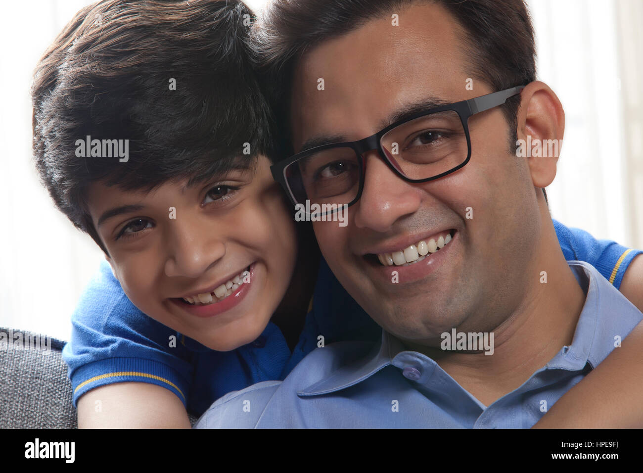 Close up of Smiling father and son looking at camera Stock Photo