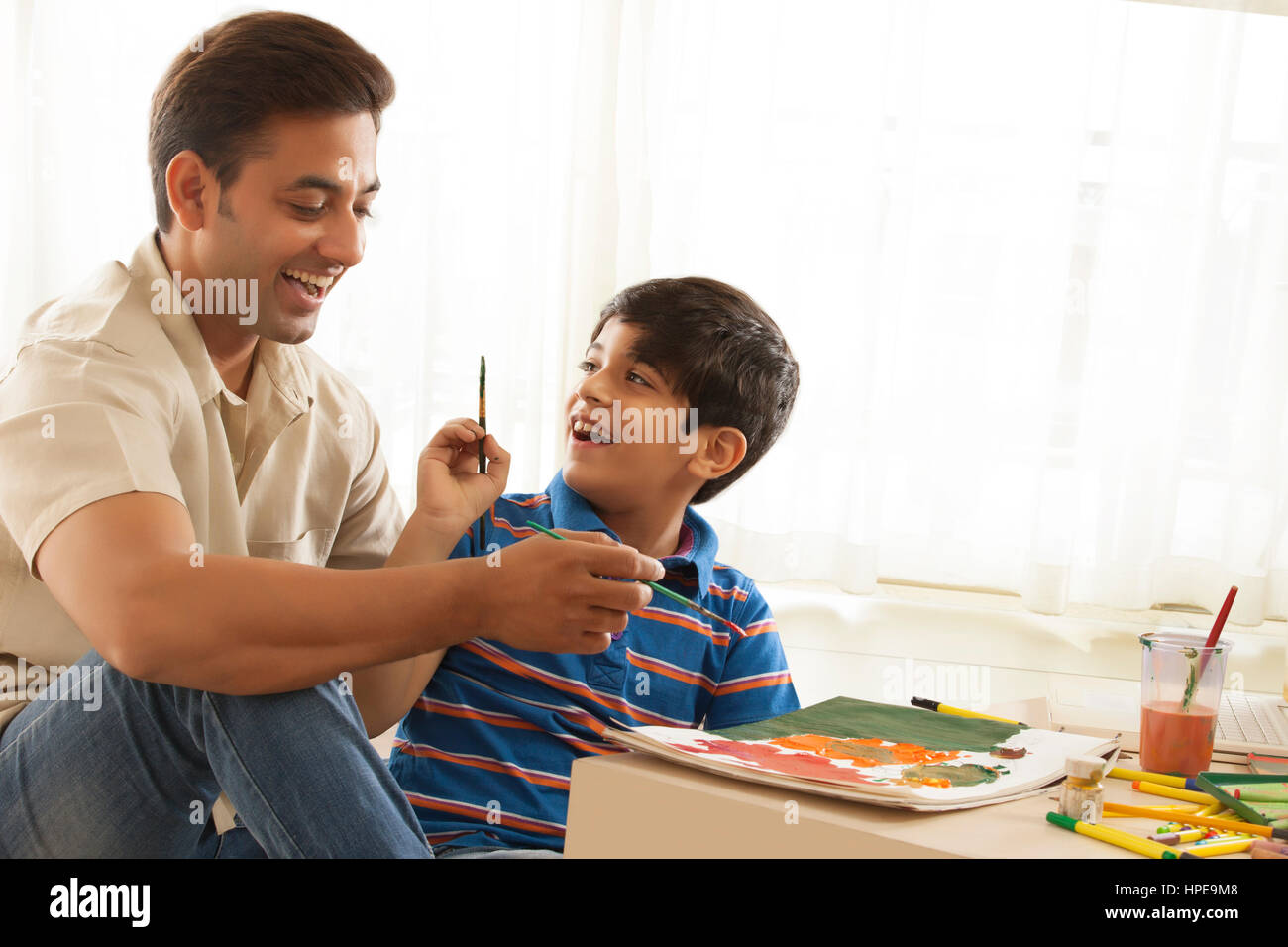 Son and father painting hi-res stock photography and images - Alamy
