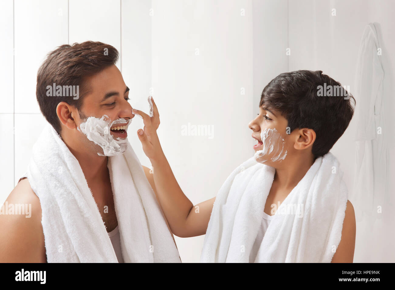 Father and son putting shaving cream on face Stock Photo Alamy