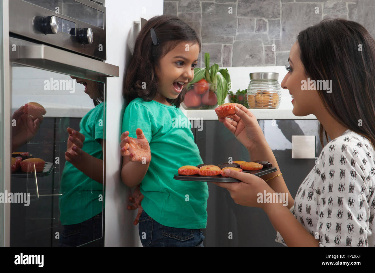 Waitress serving birthday cake to mother and daughter - Stock Image -  F033/5627 - Science Photo Library