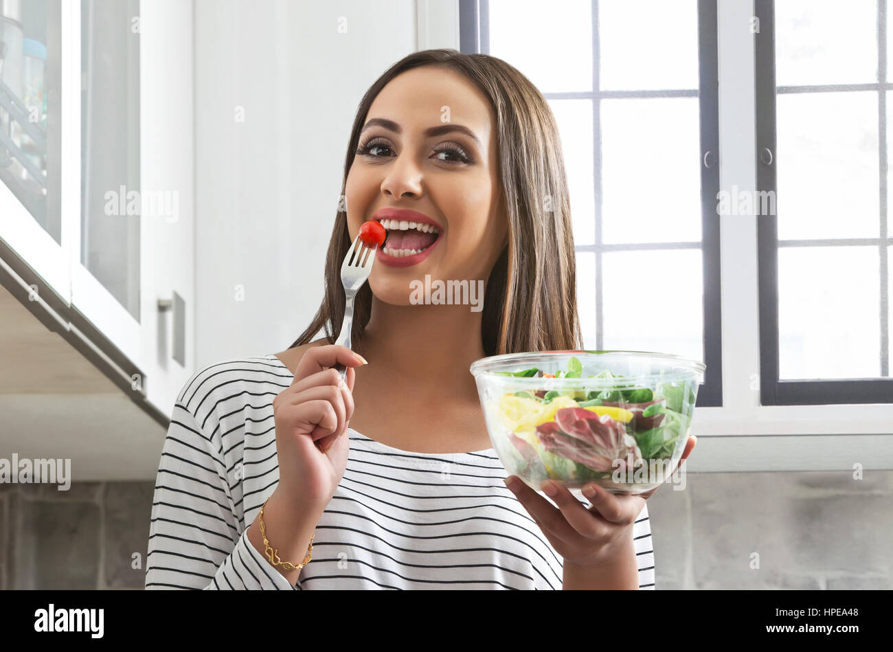 Close-up of a woman eating vegetable salad Stock Photo