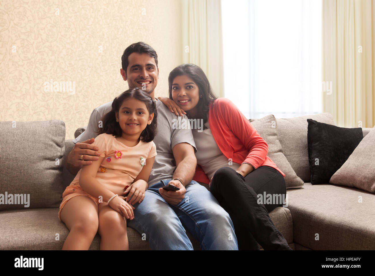 Happy family watching TV at home Stock Photo