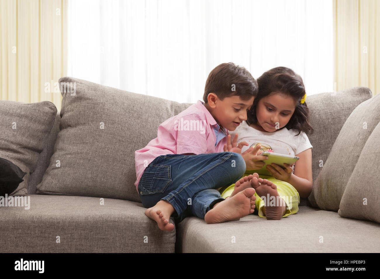 Brother and sister using digital tablet Stock Photo - Alamy