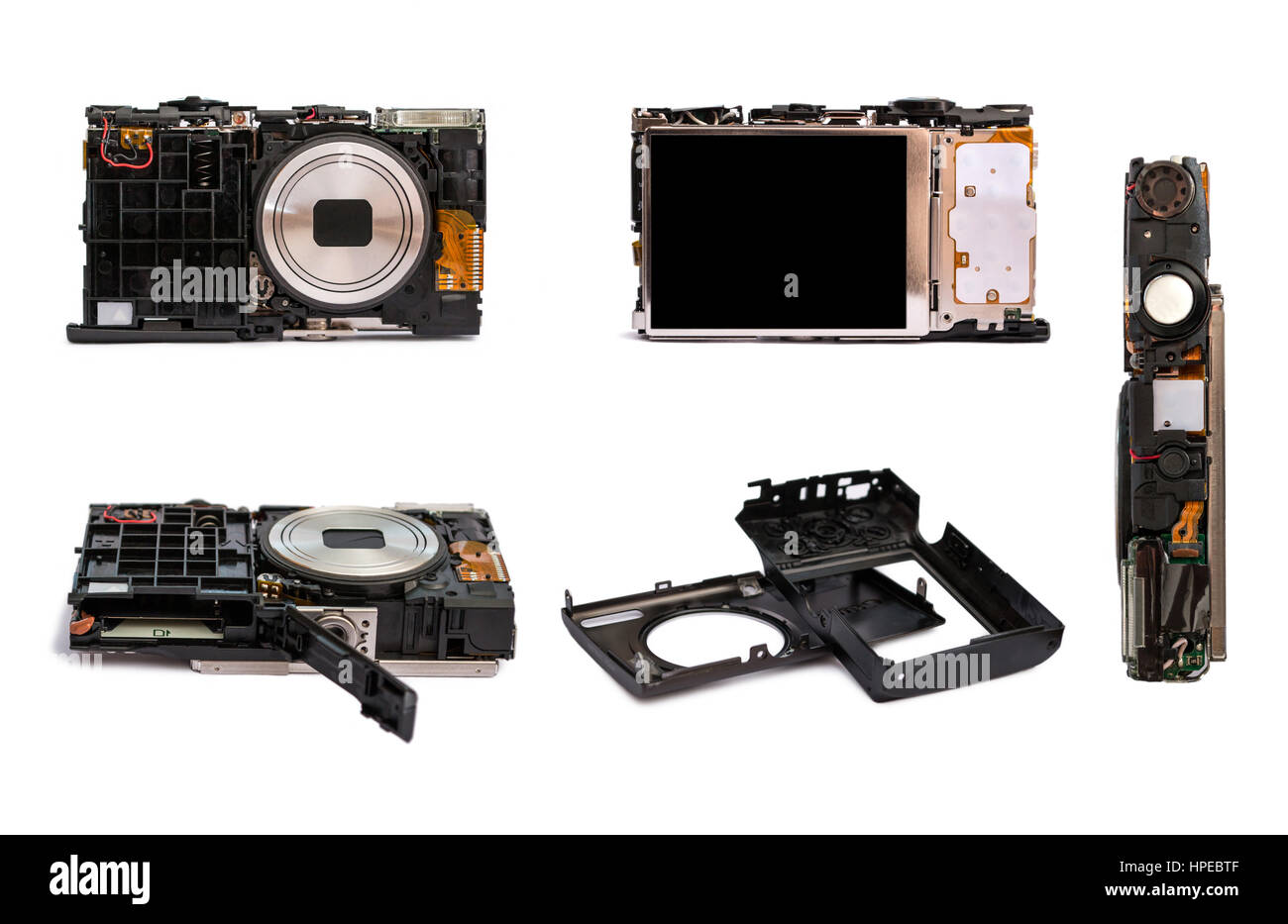 Disassembled digital camera from different angles. Details of the broken camera isolated on white background.Repair of photographic technique. Stock Photo