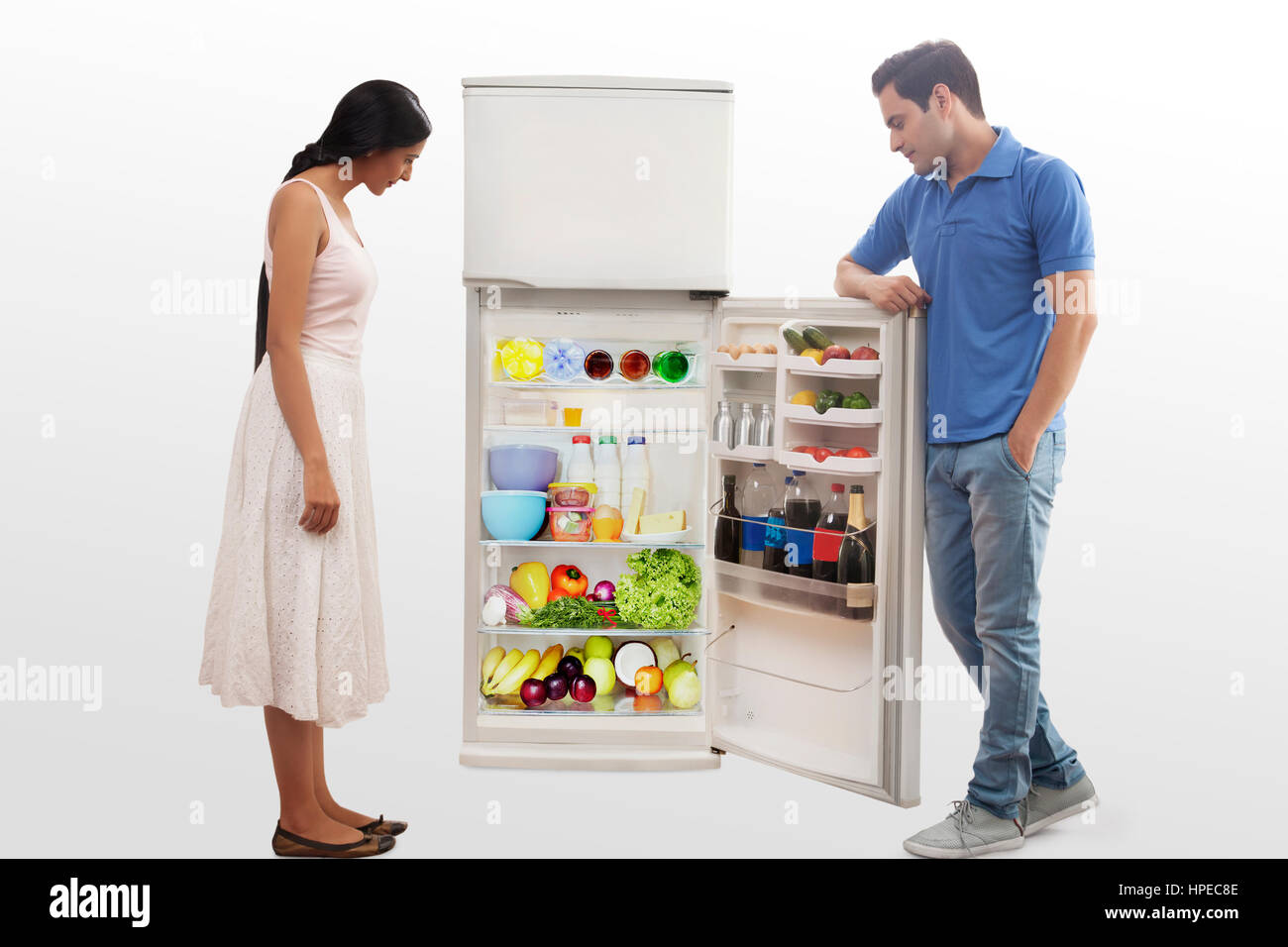 Young couple searching food in the fridge Stock Photo