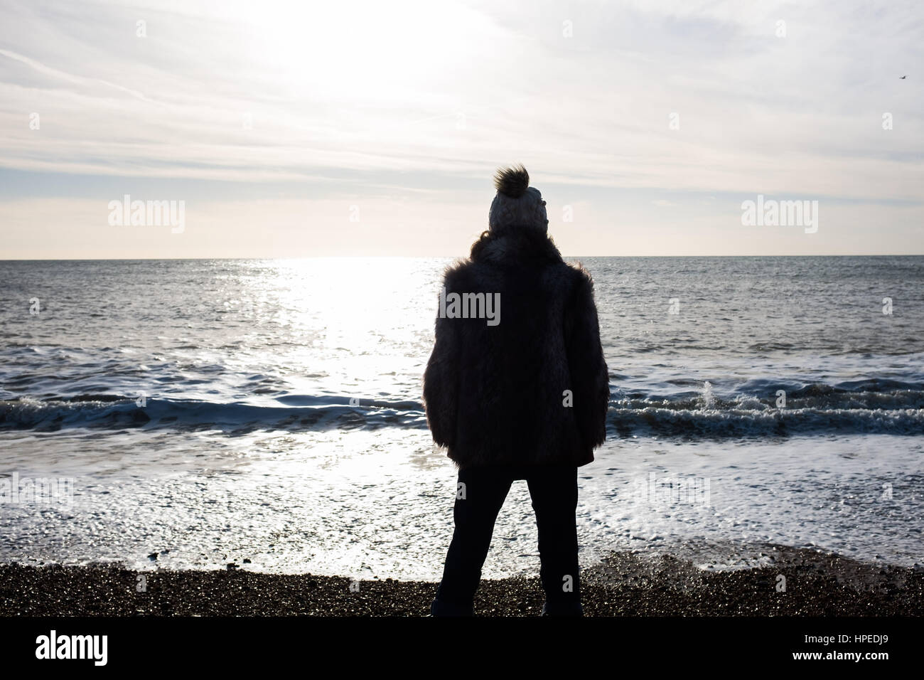 Woman looking out to sea backlight hires stock photography and images