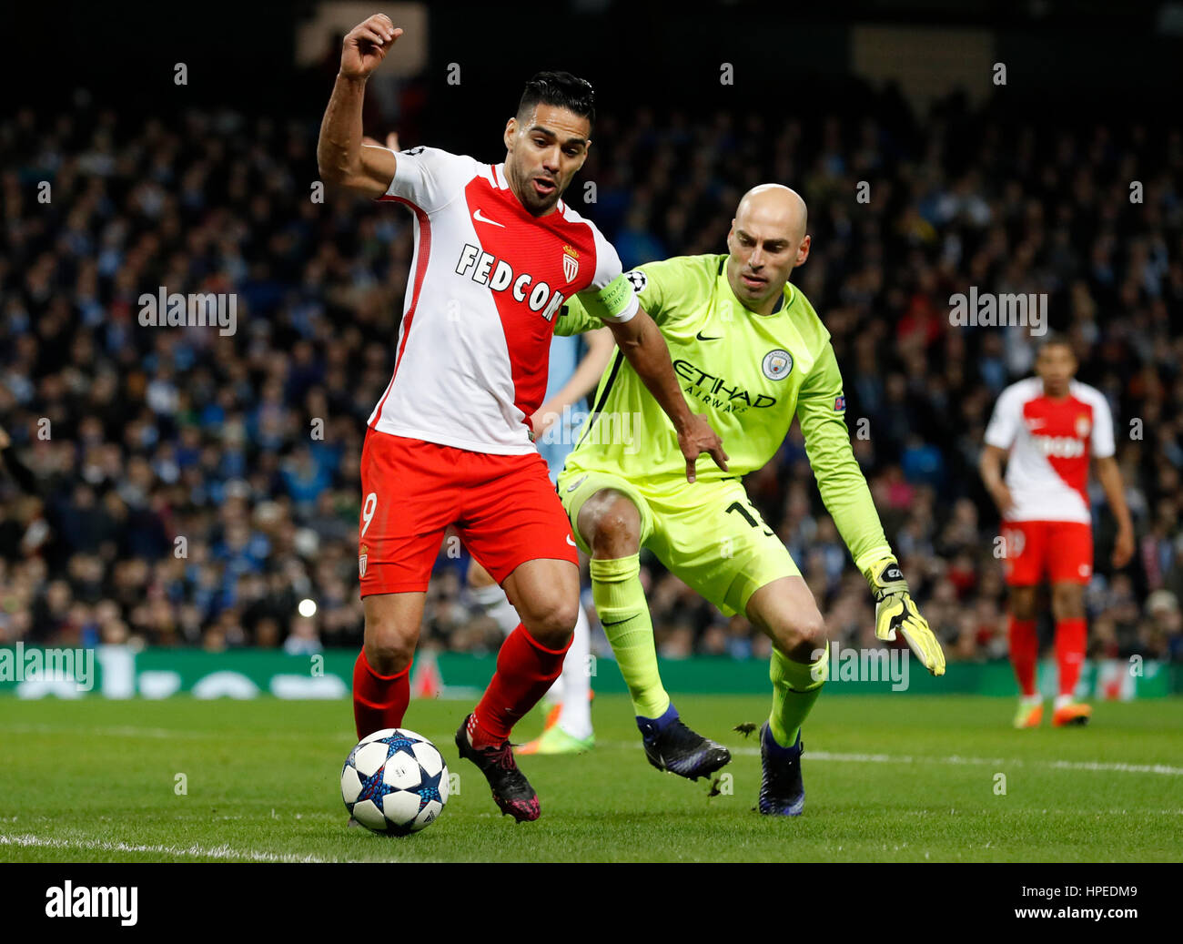 Manchester City goalkeeper Willy Caballero and Monaco's Radamel Falcao (right) battle for the ball during the UEFA Champions League match at the Etihad Stadium, Manchester. Stock Photo