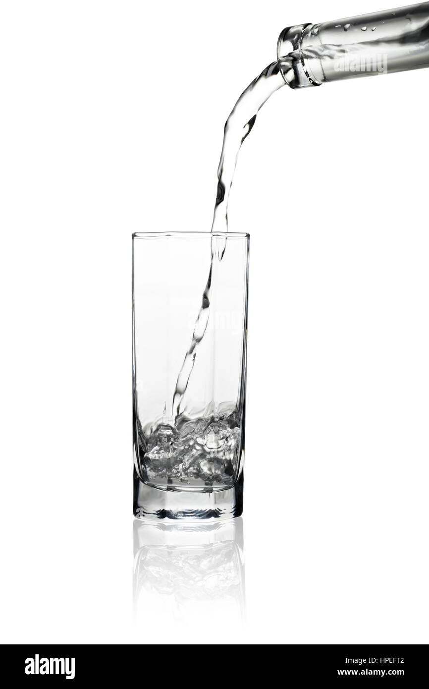 Water pouring out of bottle isolated on white background Stock Photo