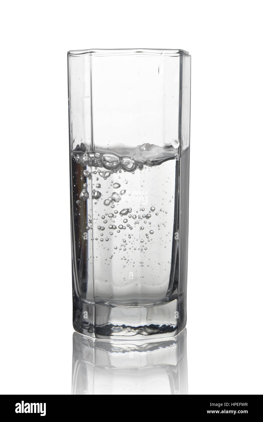 Water with air bubbles in a tall glass with its reflection isolated on