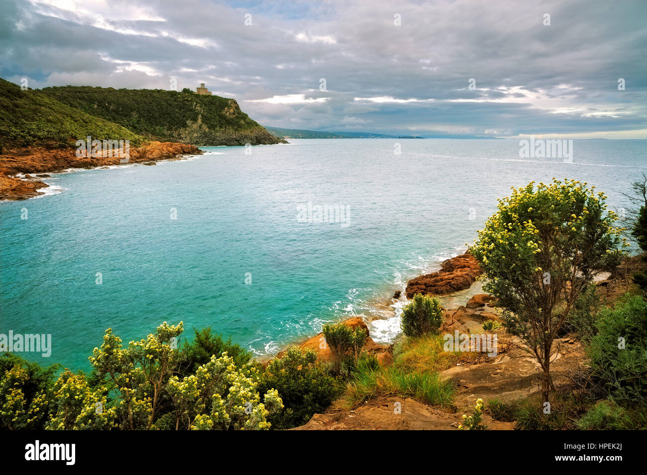 Cliff rock and building on the sea on sunset. Leghorn coast, Tuscany riviera, Italy, Europe. Stock Photo