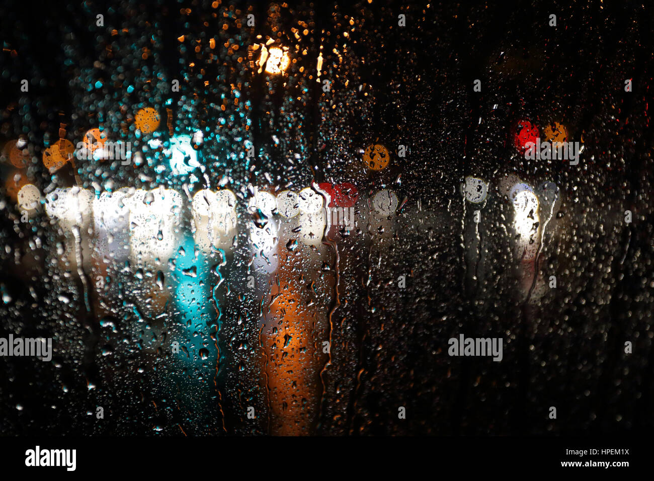 Abstract blurred rain background, view through wet car window Stock Photo