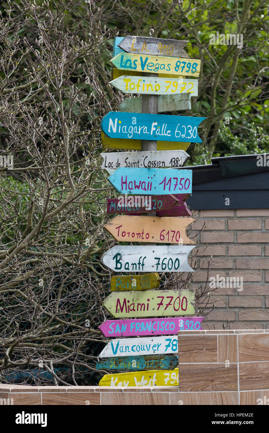 Signs pointing to popular holiday destinations with distances Stock Photo