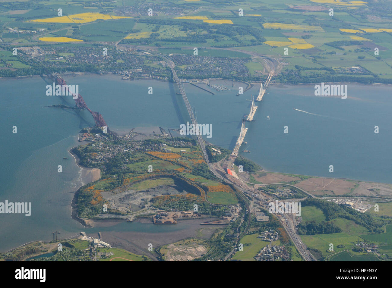 Aerial view of Queensferry Crossing during construction, and the Forth Road Bridge and Forth Bridge, crossing the Firth of Forth, Edinburgh, Scotland Stock Photo