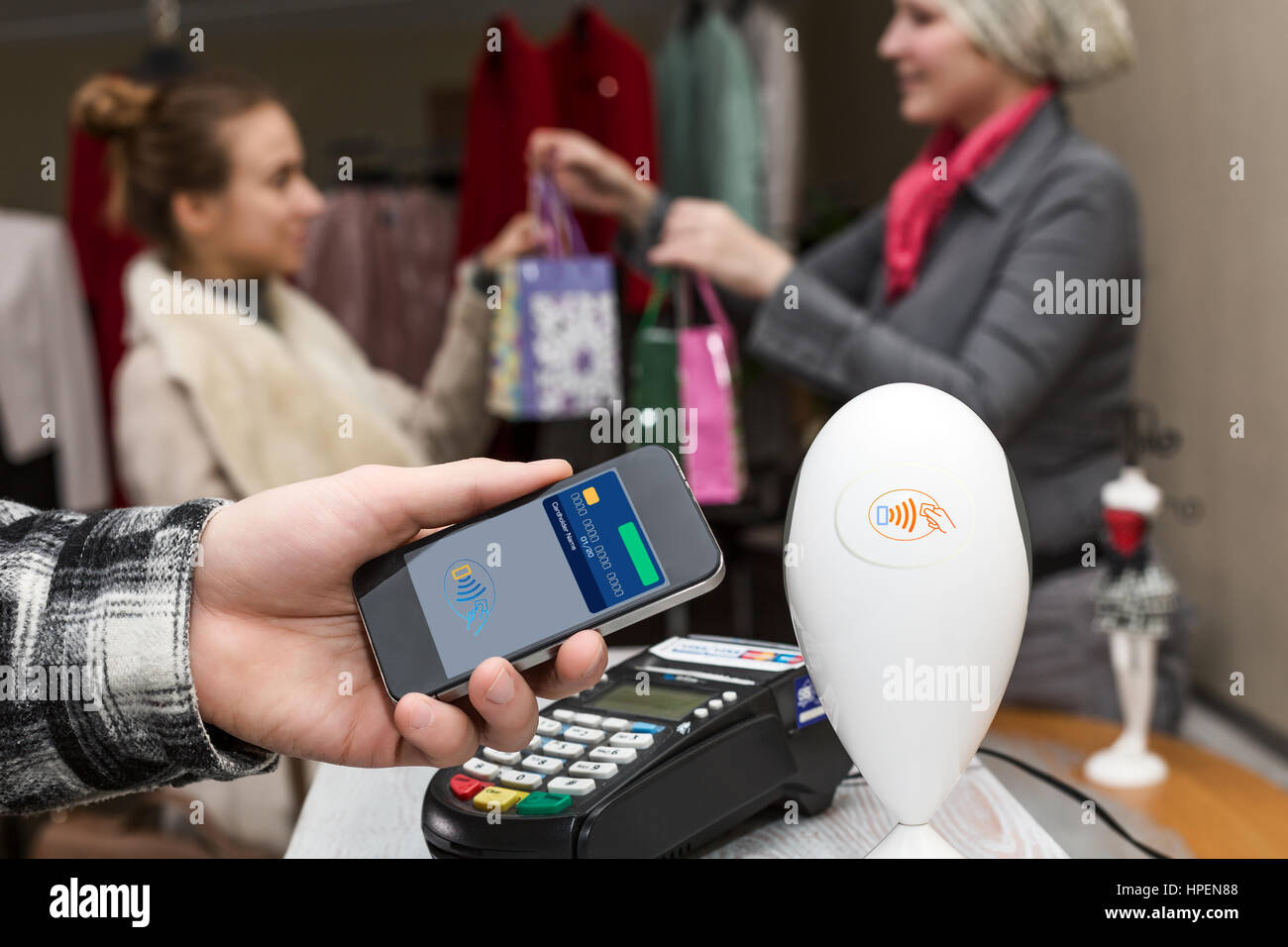 Man completing mobile Payment using modern smart Phone Technology at