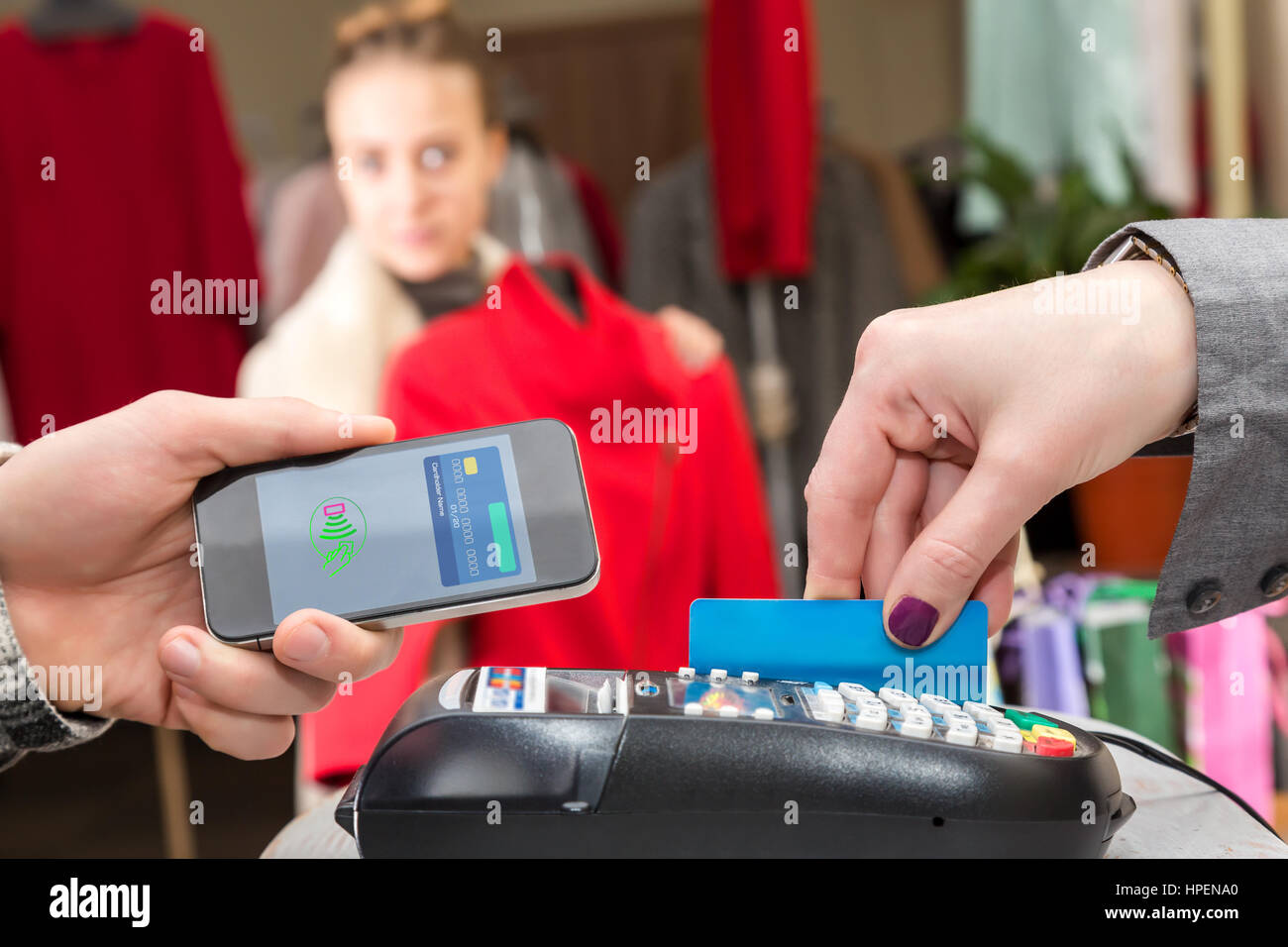 Near Field Communication Man completing mobile Payment Woman shopping
