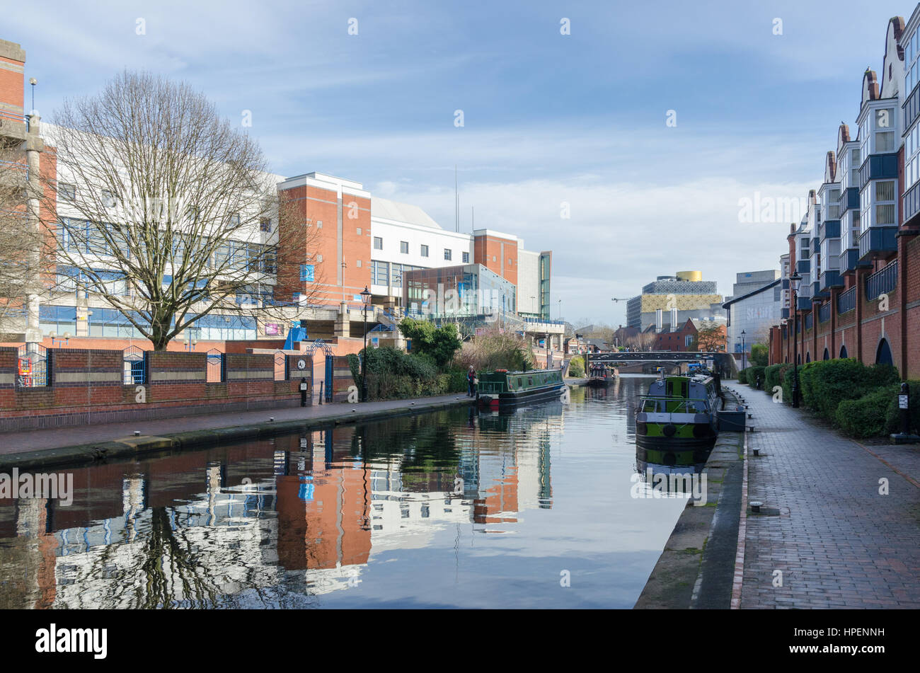 View along a canal in Birmingham looking towards Brindley Place and Library of Birmingham Stock Photo