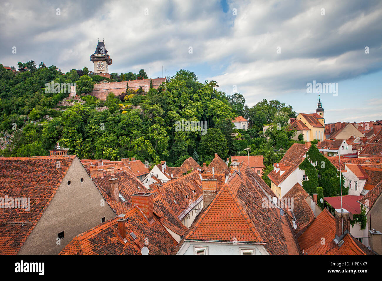 Cityscape with Schlossberg or Castle Hill mountain with old clock tower Uhrturm, Graz, Austria Stock Photo