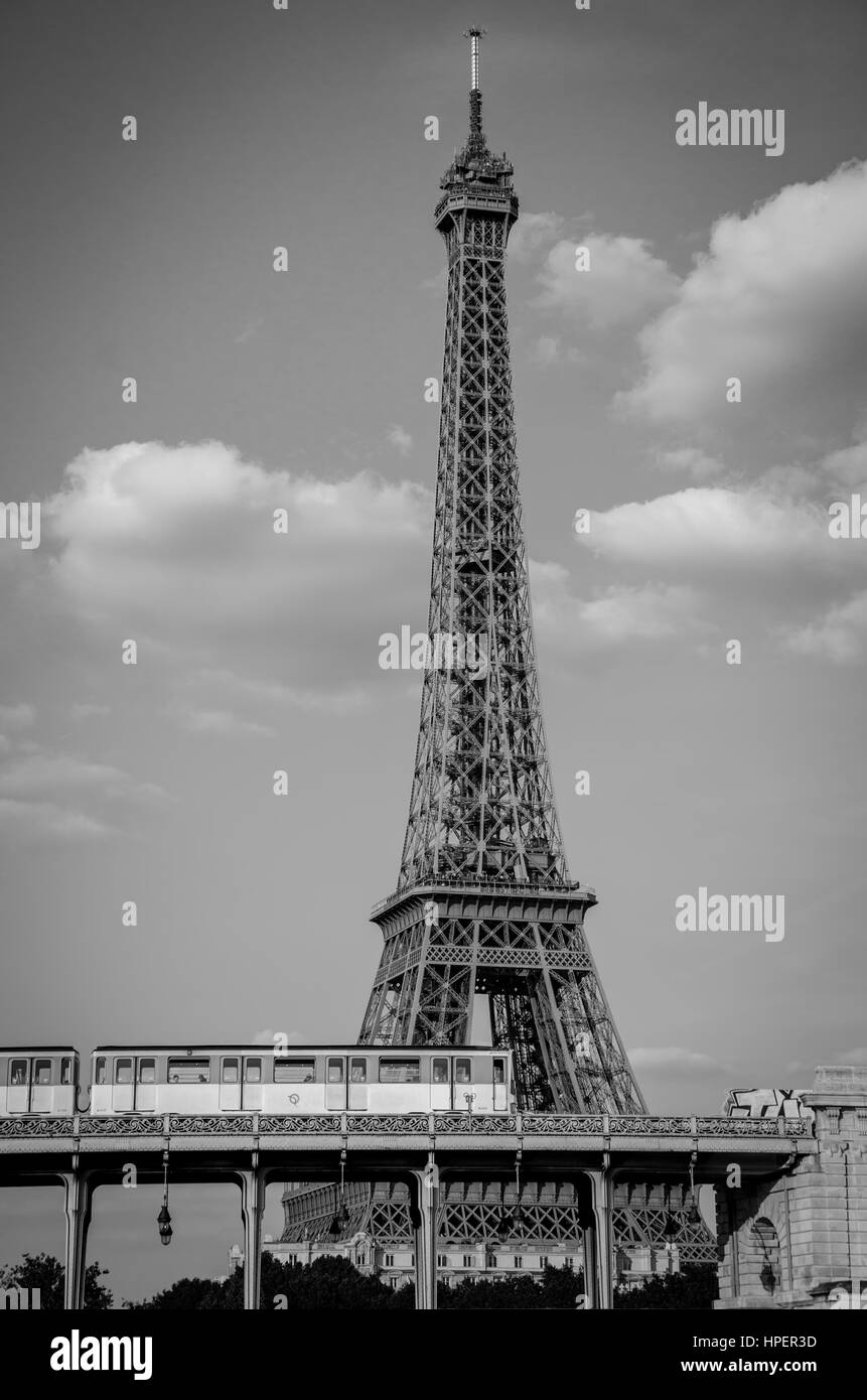 A metro train passing in front of the iconic Eiffel Tower in Paris