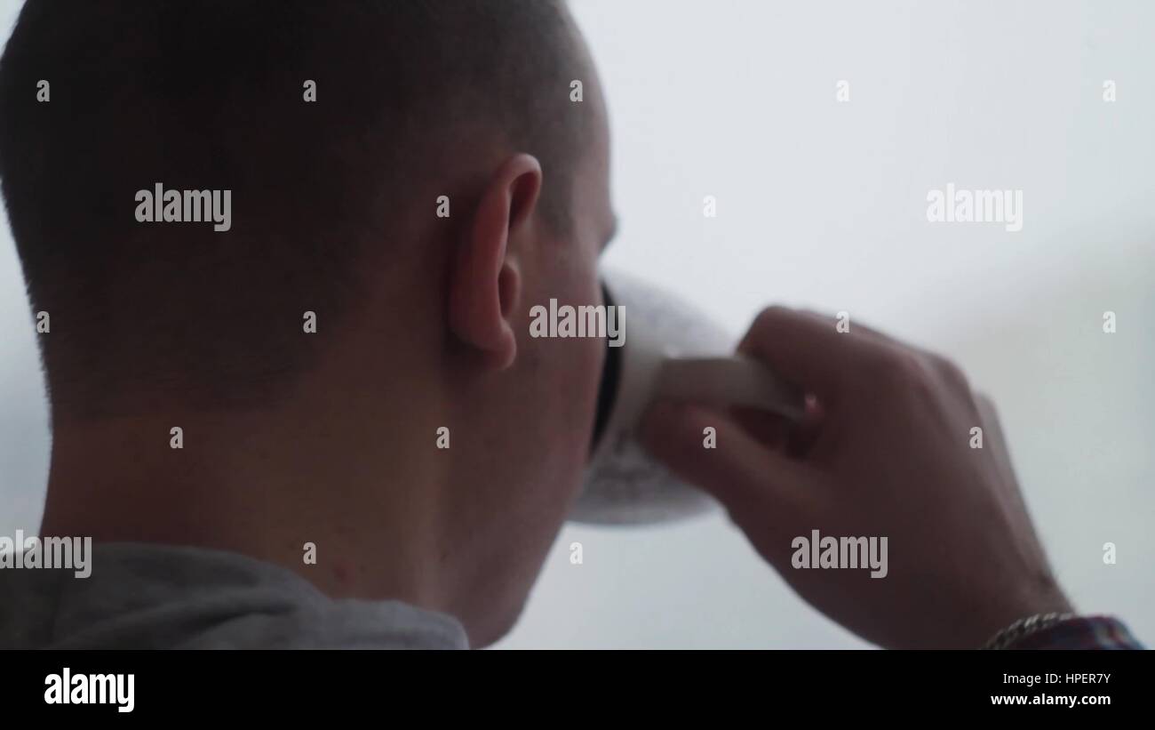 Sad, depressed man drinking tea by the window in home Stock Photo - Alamy