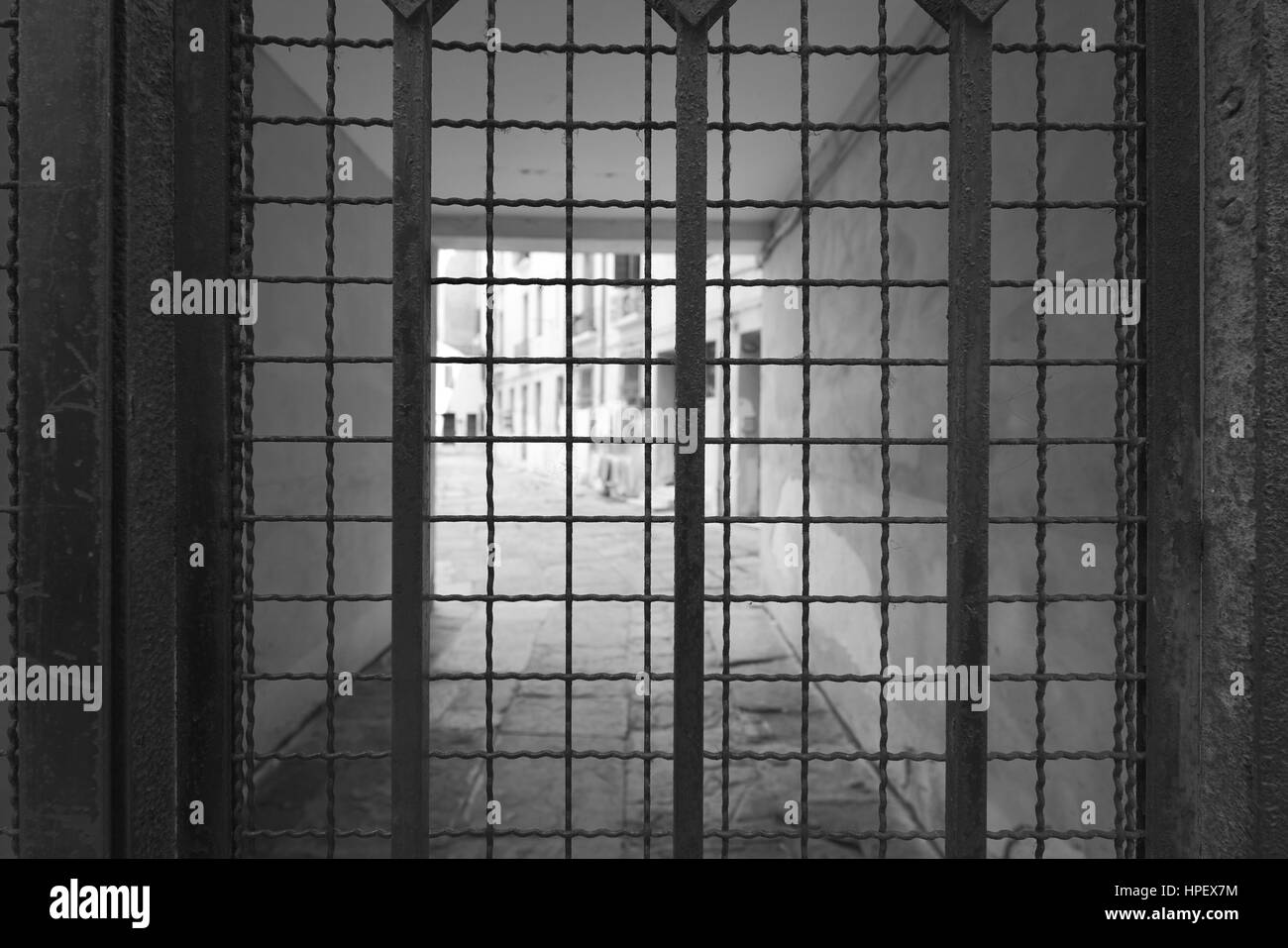 Looking Through A Barred Door Into A Courtyard Stock Photo