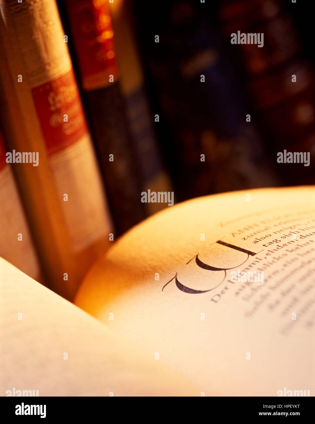 open book with writing and initial in warm light Stock Photo