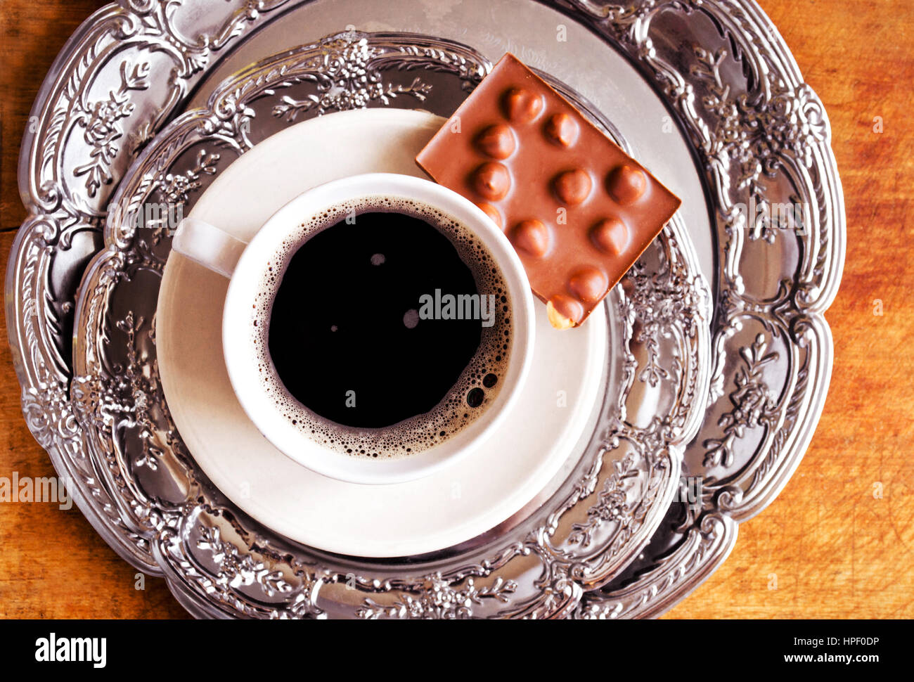 Coffee cup and chocolate bar on vintage plate Stock Photo