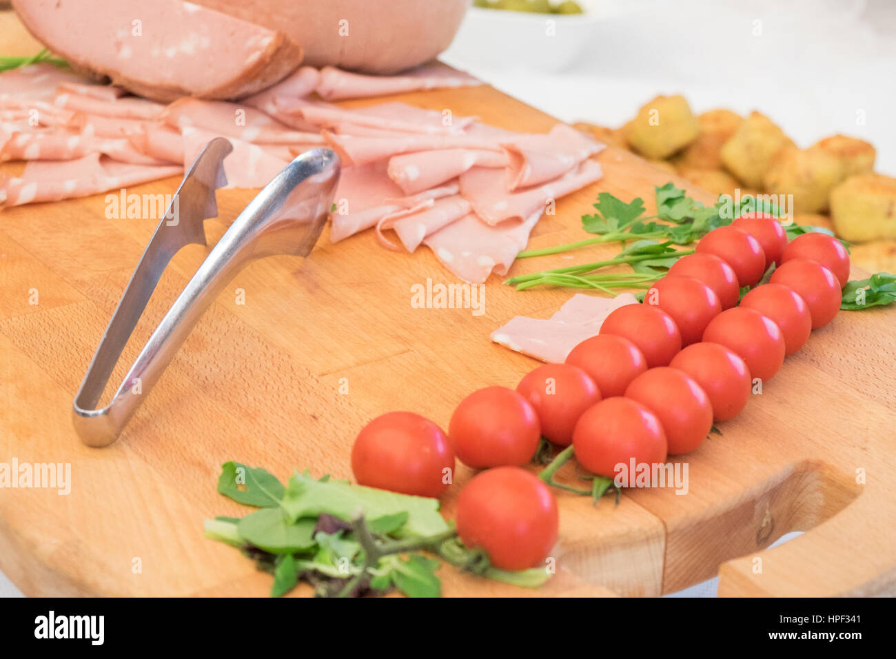 Bologna ham slices served on a wooden tray Stock Photo - Alamy