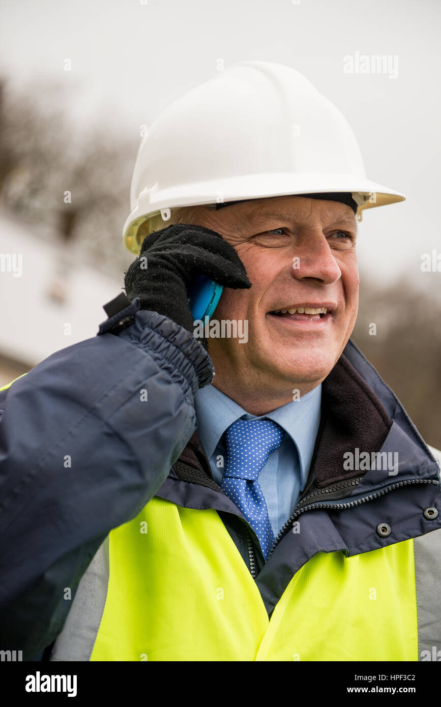 Civil engineer talking on cell phone. Stock Photo