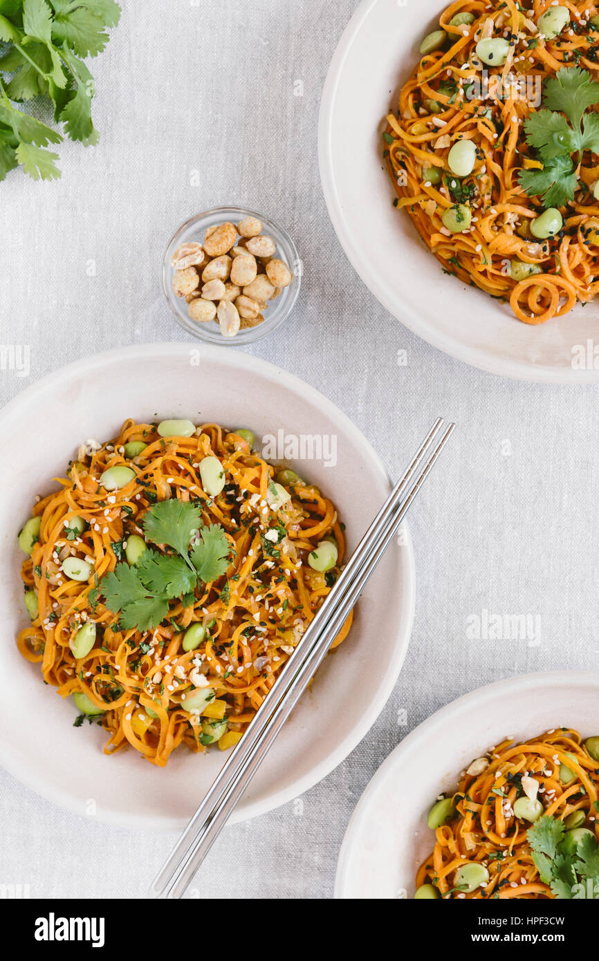 3 bowls of sweet potato noodle pad thai are photographed from the top view. Stock Photo
