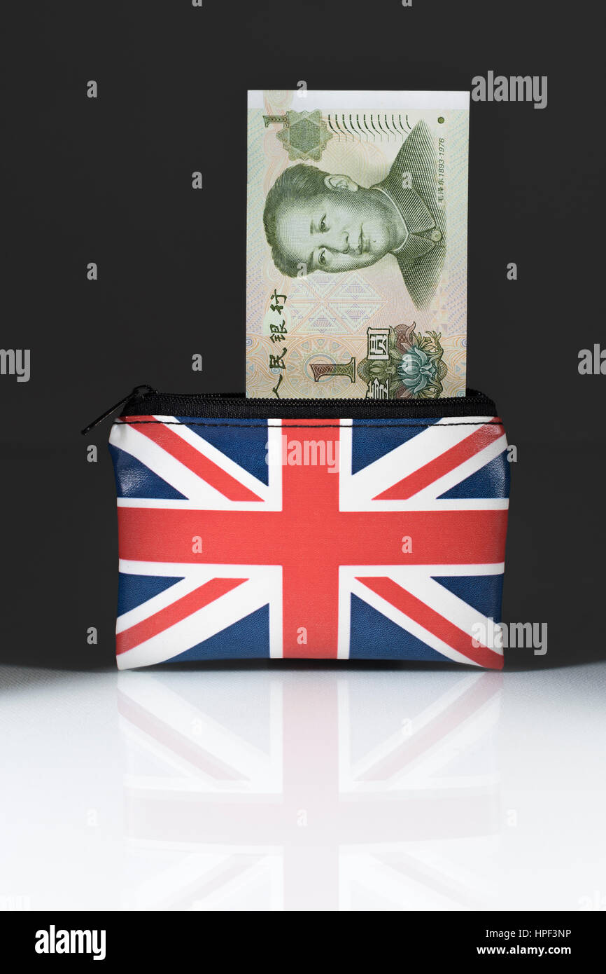 Union Jack coin purse with Chinese Yuan / Renminbi ... against a dark background. Metaphor for Yuan-Pound exchange rate. China-UK trade, Yuan weakness Stock Photo
