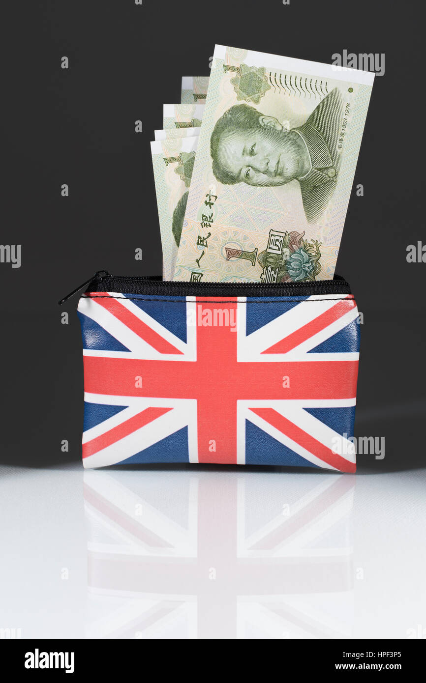 Union Jack coin purse with Chinese Yuan / Renminbi ... against a dark background. Metaphor for Yuan-Pound exchange rate. China-UK trade, Yuan weakness Stock Photo