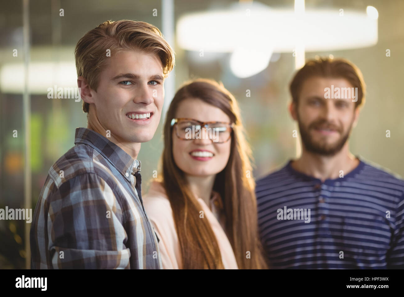 Portrait of happy business executives standing in office Stock Photo ...