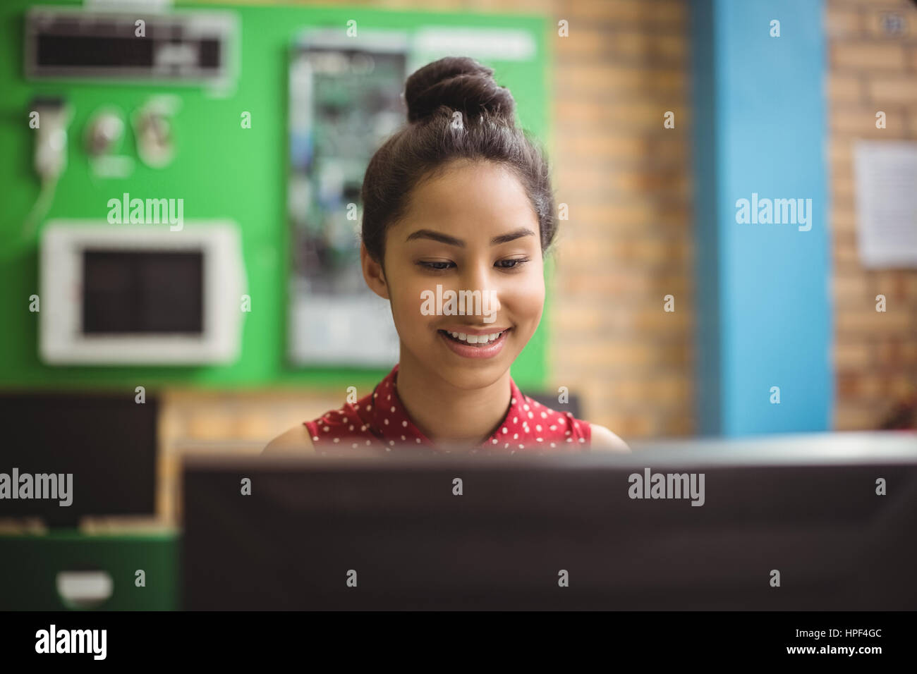 Smiling schoolgirl studying in computer classroom at school Stock Photo ...