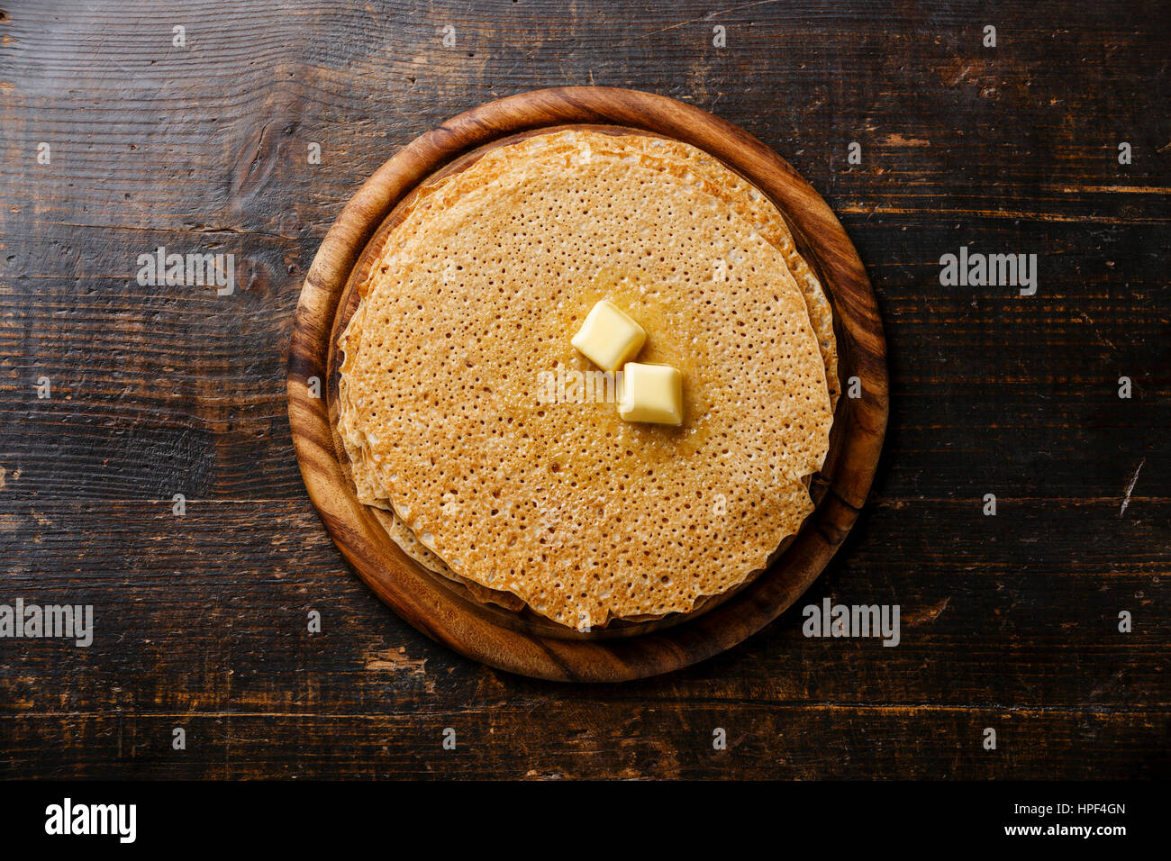 Pancakes with butter on wooden background Stock Photo
