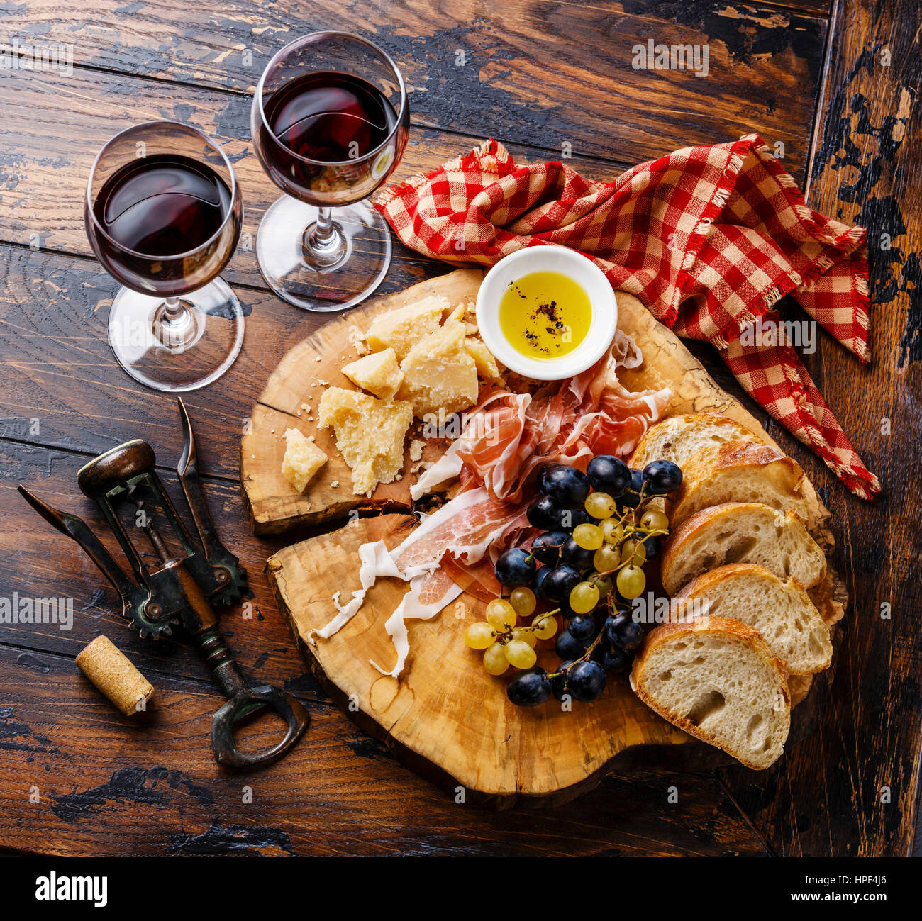 Appetizer ham and cheese plate with wine on wooden table background Stock Photo
