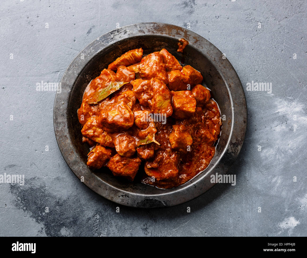 Chicken tikka masala spicy curry meat food in metal plate close-up Stock Photo