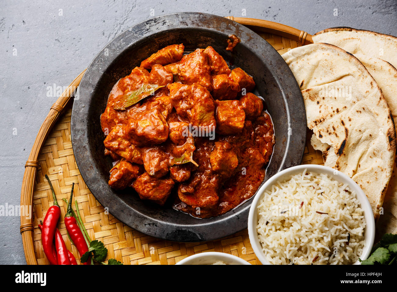 Chicken tikka masala spicy curry meat food in metal plate, rice and naan bread close-up Stock Photo