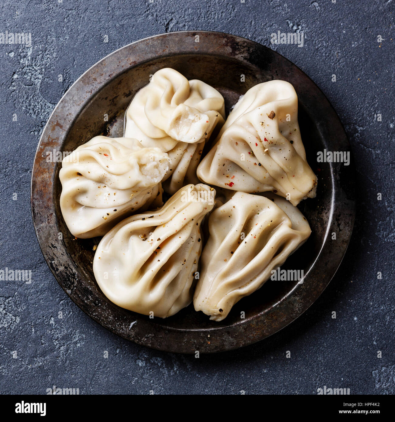 Georgian dumplings Khinkali with meat on metal plate Stock Photo