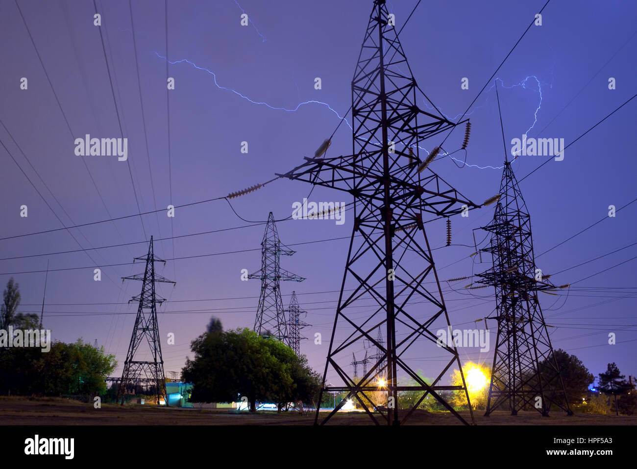 Power transmission lines being struck by lightning during the night thunderstorm Stock Photo