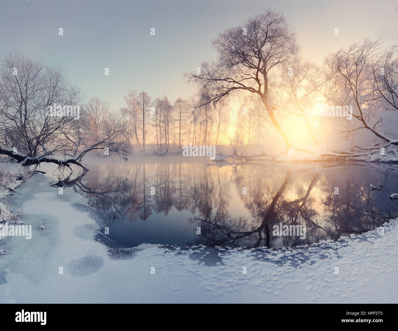 Bright sunlight in Christmas morning. Beautiful winter landscape. Colorful winter sunrise. Stock Photo
