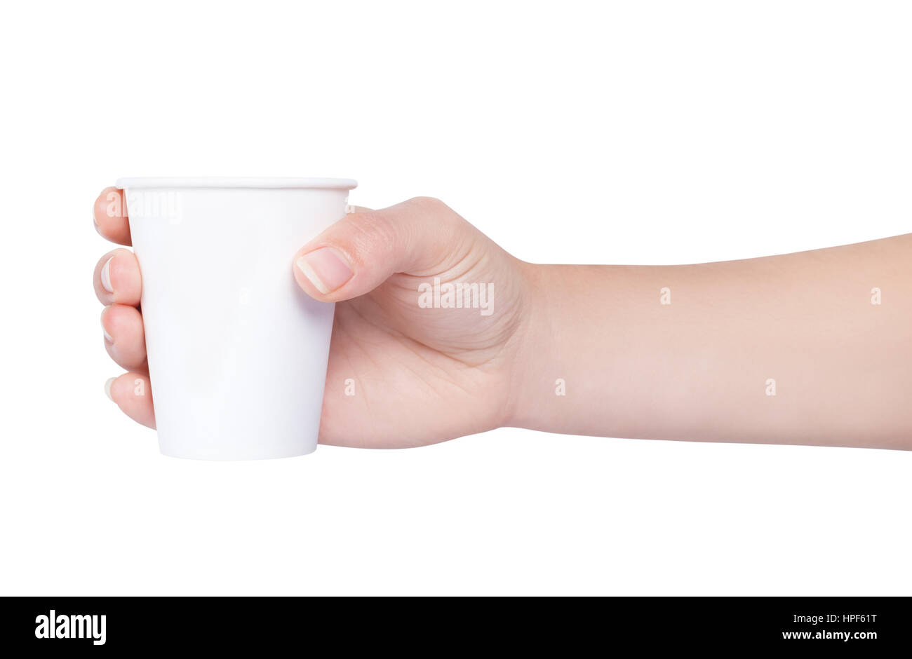 Hand holding white paper cup isolated on white background. Female hand