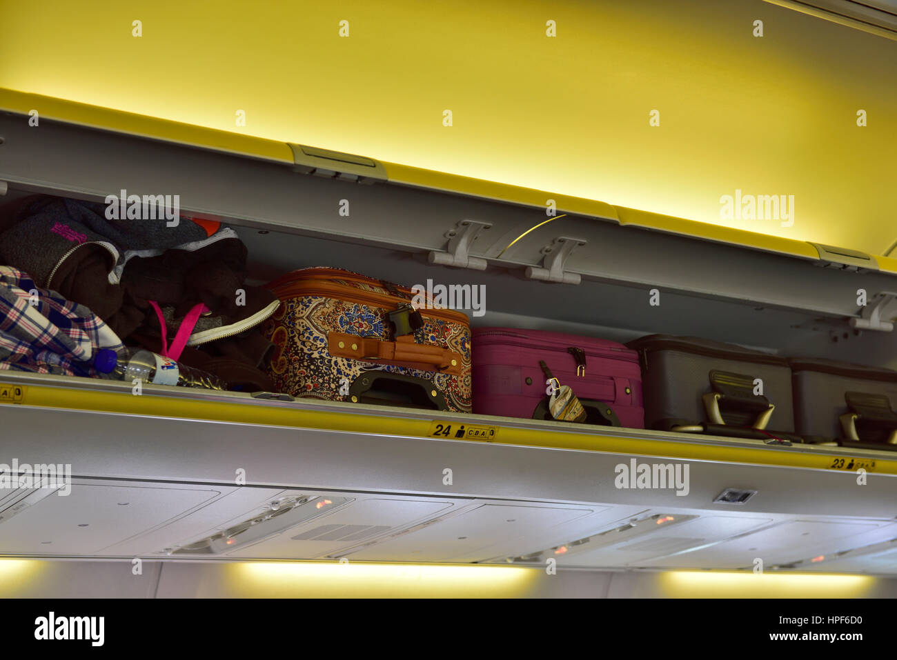 Overhead locker inside cabin on airplane Stock Photo Alamy