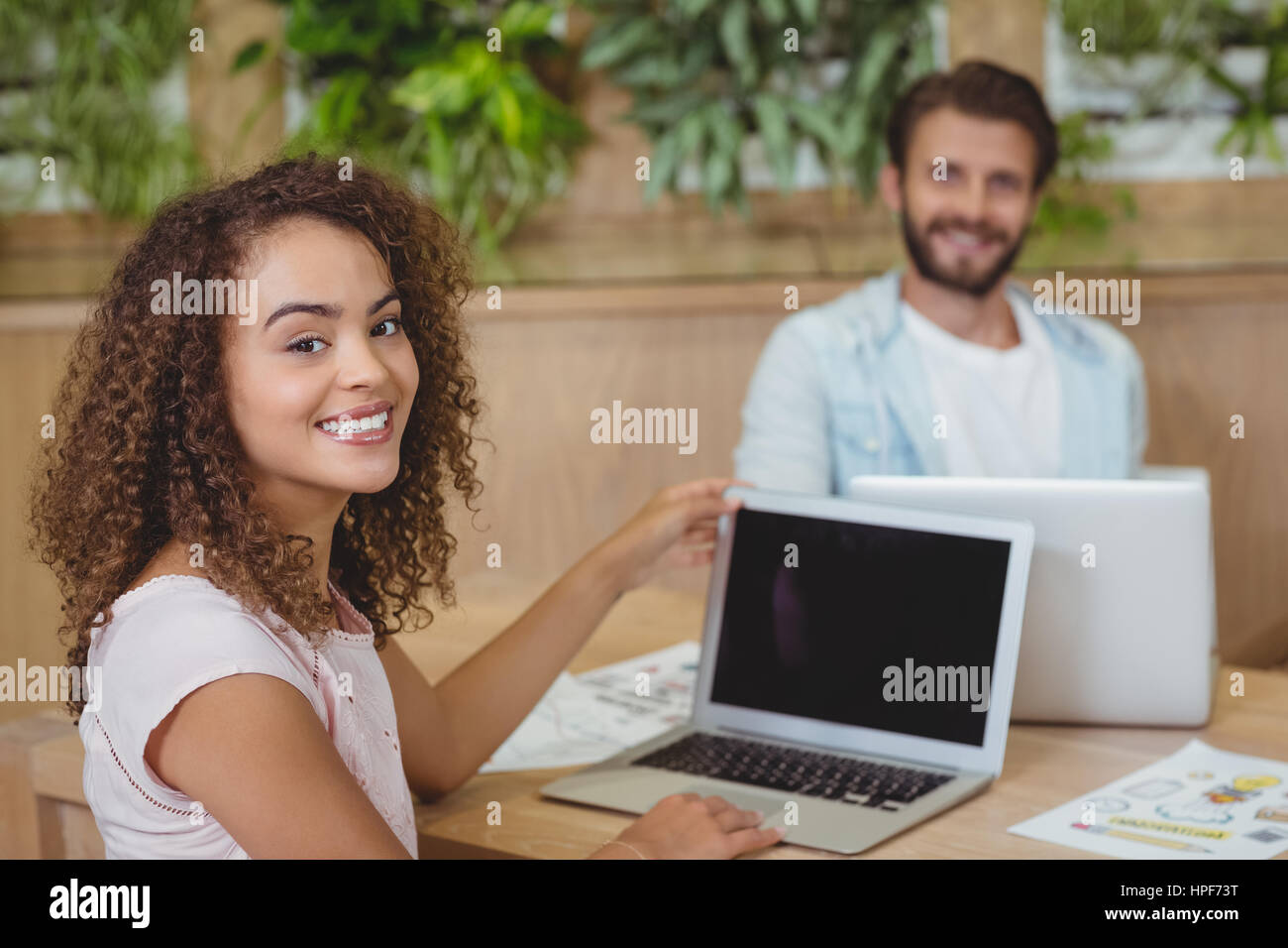 Portrait of Business executives sitting at desk and using laptop in ...