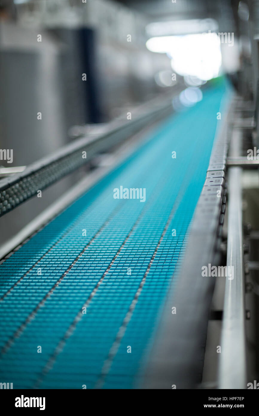 Close-up of conveyer belt in bottle factory Stock Photo