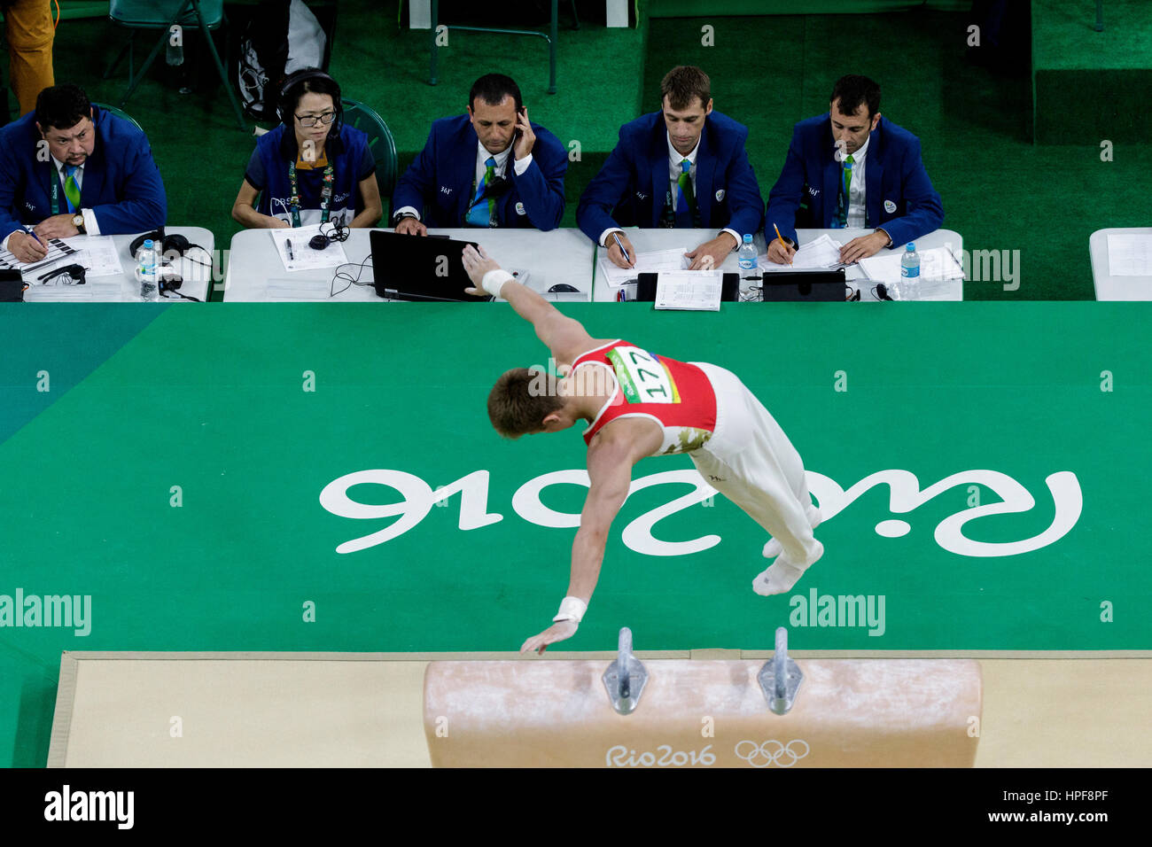 Rio de Janeiro, Brazil. 08 August 2016. Judges watching Ivan Stretovich (RUS) performs on the pommel horse during Men's artistic team final at the 201 Stock Photo