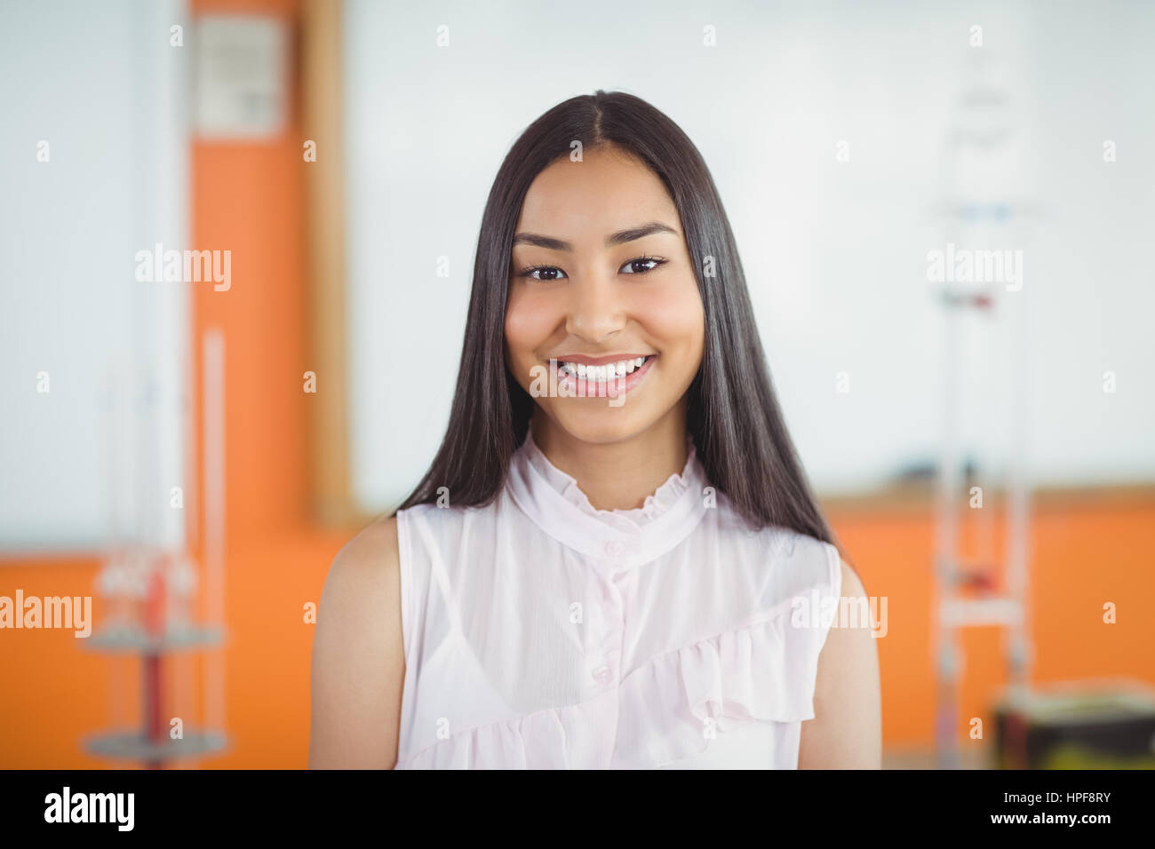 Portrait of smiling schoolgirl in classroom at school Stock Photo - Alamy